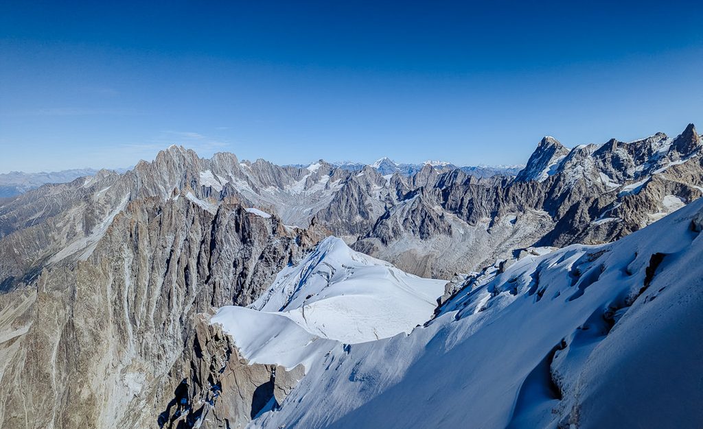 Glacier tongue with debris and snow slopes below Mont Blanc